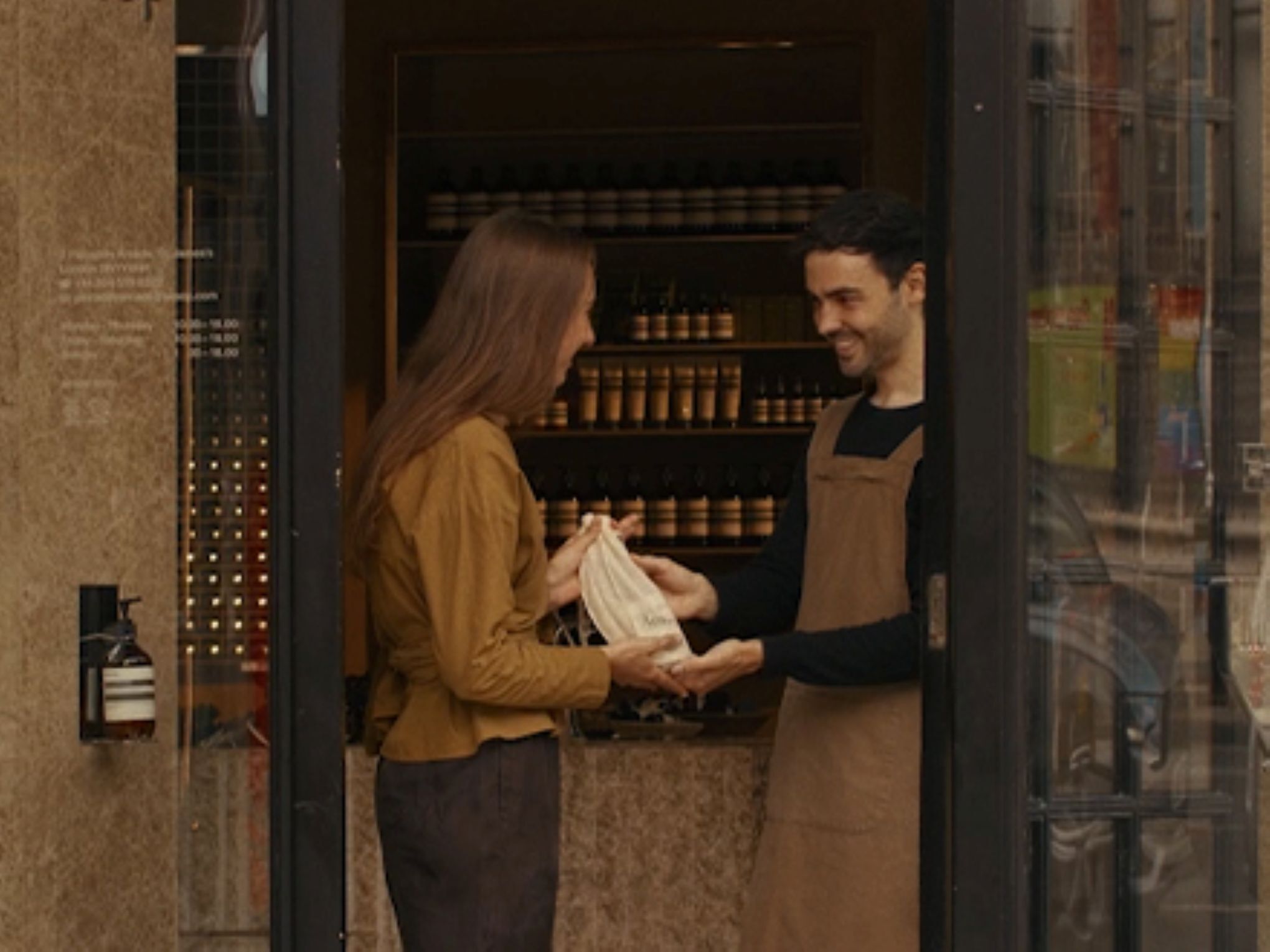 A hand care consultation in an Aesop store, beside a complimentary 15mL Eleos Aromatique Hand Balm offered upon email subscription.​