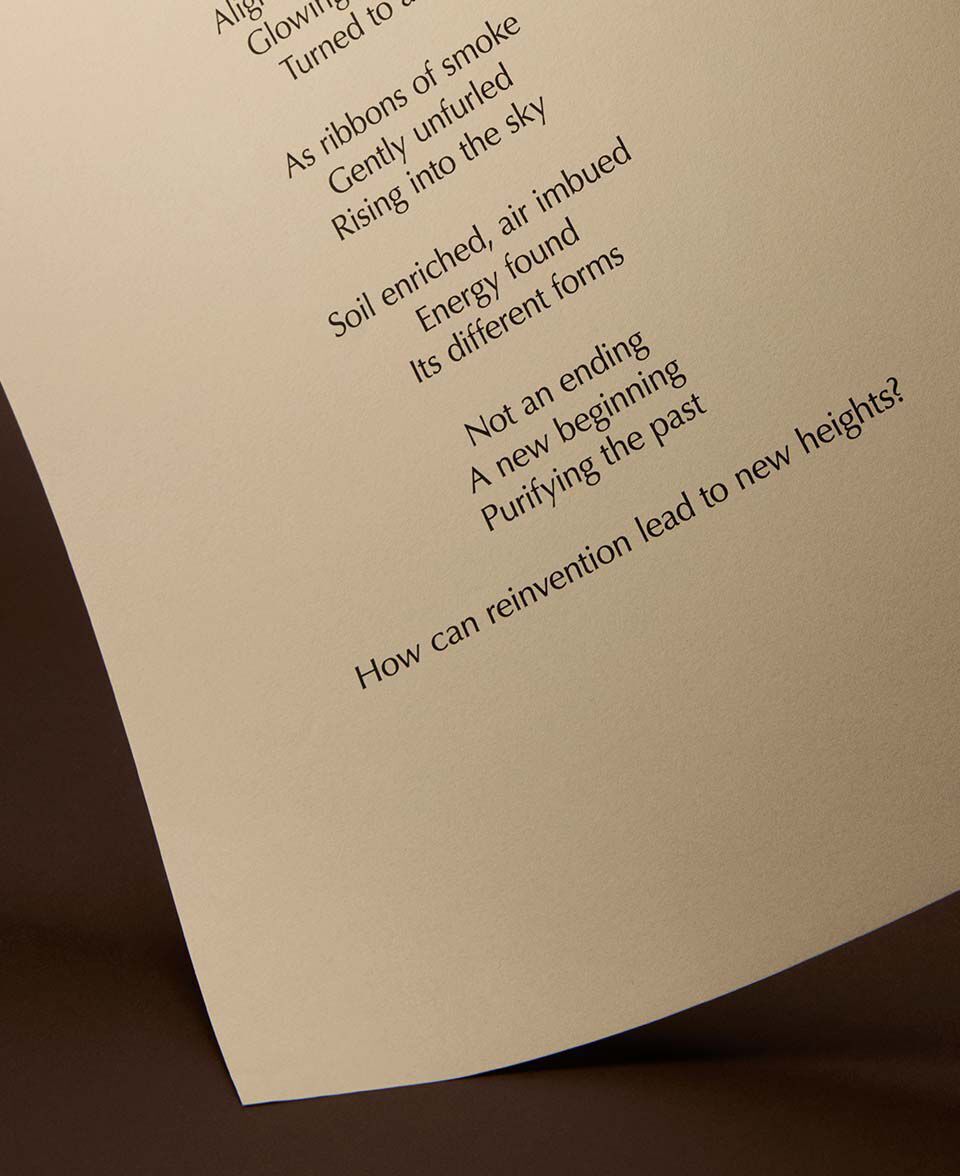 Cream page with poem text angled over a warm brown surface.